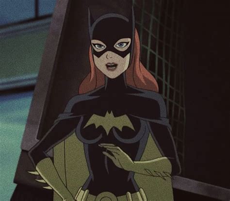 The Animated Batgirl Is Standing In Front Of A Building With Her Hands