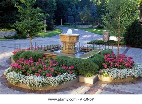Stock Photo Small Fountain And Bordering Circular Gardens Include