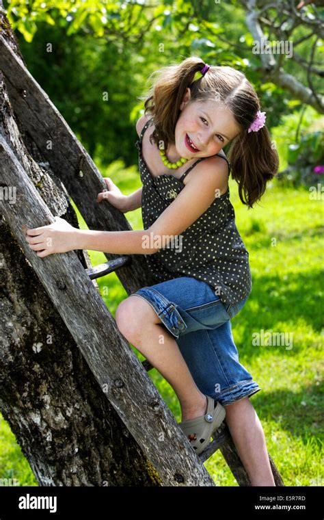 7 Year Old Girl Climbing Ladder Stock Photo Alamy