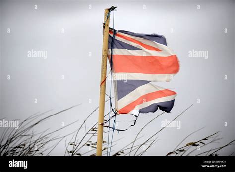 A British Flag Torn In A Gale Uk Stock Photo Alamy