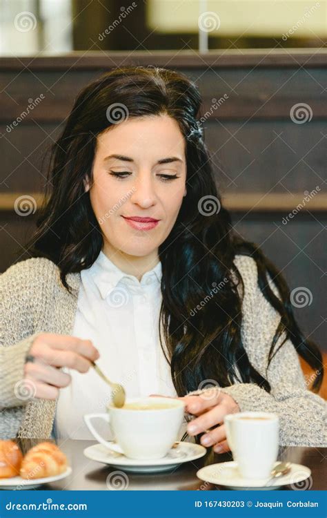 Beautiful Brunette Woman Having Breakfast Drinking Coffee In A European