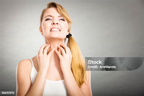 Woman Scratching Her Itchy Neck With Allergy Rash Stock Photo