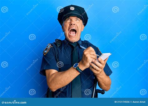 Handsome Middle Age Mature Man Wearing Police Uniform Writing A Ticket