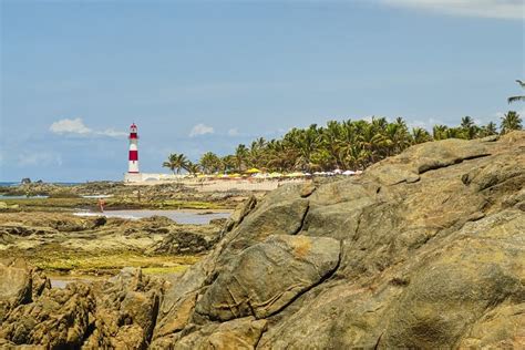 Itapua Beach With Lighthouse In Background With Blue Sky With Clouds