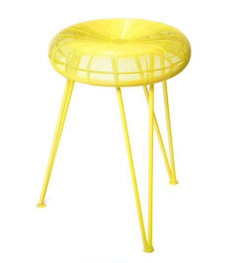 a yellow stool that is sitting on top of a white floor and it s legs are bent to the side