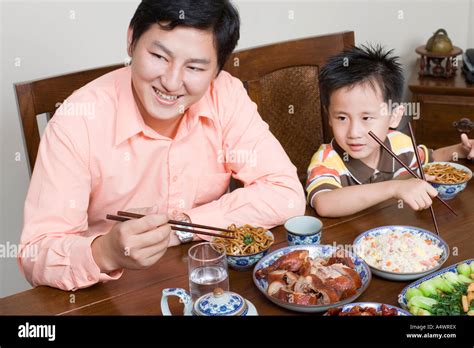 Father And Son Eating Dinner Stock Photo Alamy