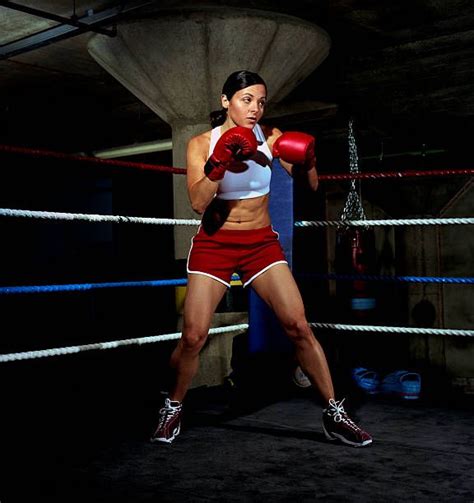 A Woman Wearing Red Shorts And Boxing Gloves