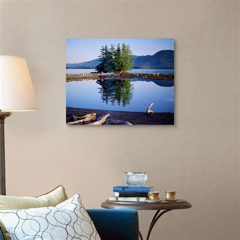 Coastal Scene With Pine Trees And Water Reflection Inside Passage