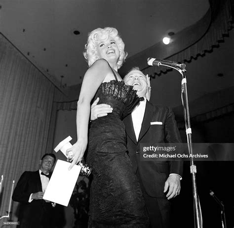 actress jayne mansfield presents a golden globe award to actor mickey news photo getty images