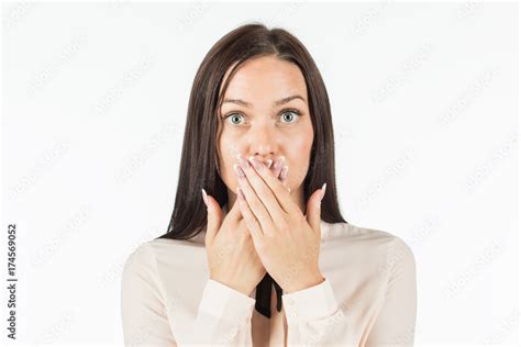 keep quiet a frightened woman covering her mouth with her hands putting her camera on the
