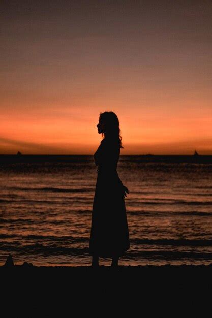 Premium Photo Side View Of Silhouette Woman Standing At Beach During