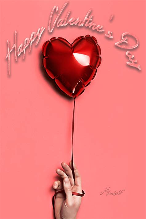 a hand holding a heart shaped balloon with the words happy valentine s day on it