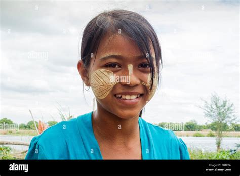 A Burmese Girl With Thanaka Paste On Her Face In The Shape Of A Leaf
