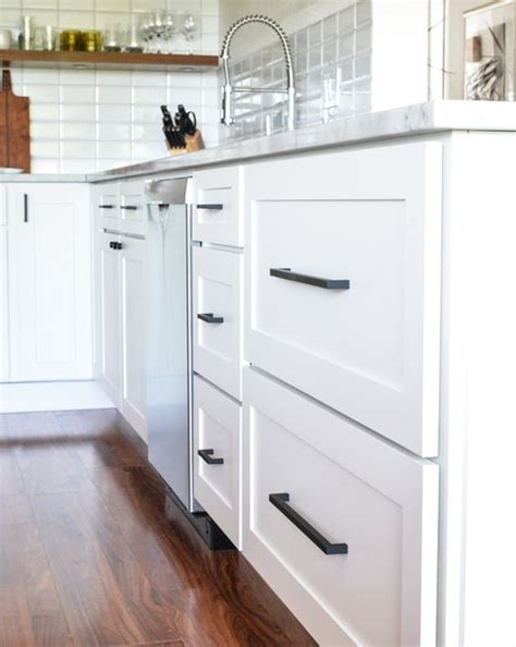If you are considering white to reface your existing kitchen cabinets, or for new cabinetry altogether, you are not alone in your color choice. Dino & Heidi's Kitchen Remodel | Kitchen cupboard handles, White shaker kitchen, Black cabinet ...