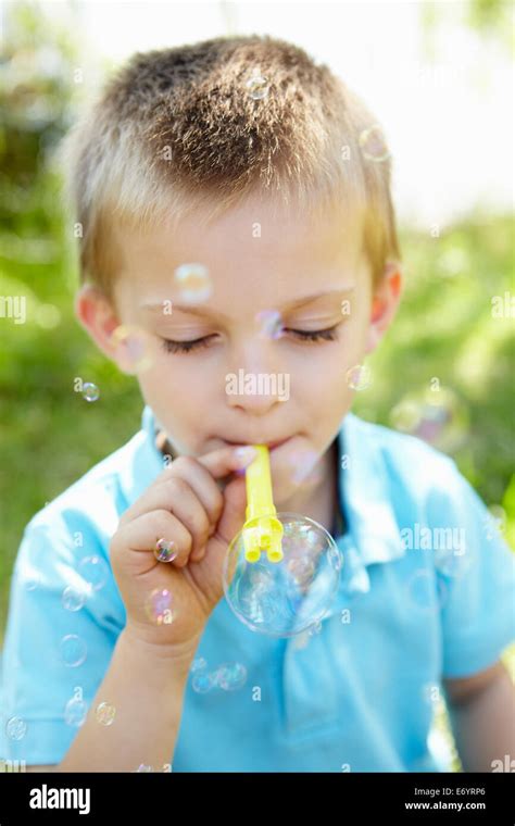 Young Boy Blowing Bubbles Outdoors Stock Photo Alamy