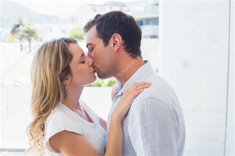 Side View Of A Loving Couple Kissing Stock Photo By Lightwavemedia