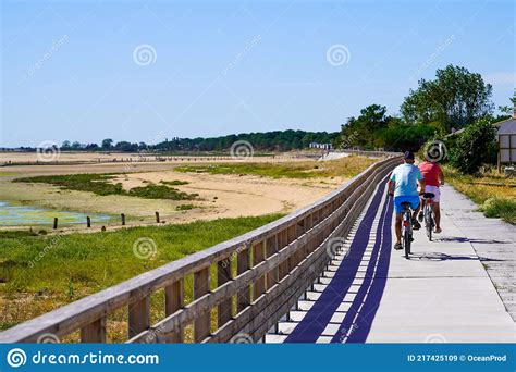 Rear View Of Tourists On Bicycles On The Waterfront Of The Atlantic