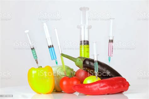 Six Syringes In Fruits And Vegetables Genetically Modified Food Concept