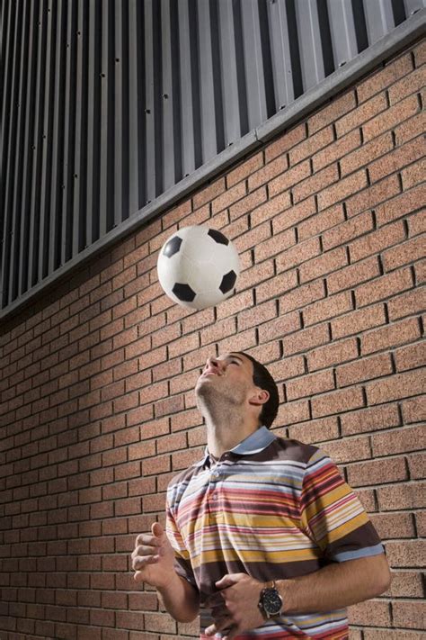 Man Bouncing Ball Off Head In Portico Stock Image Image Of Athlete