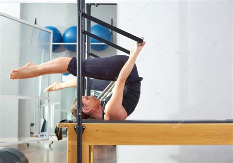 Pilates Woman In Reformer Roll Over Exercise Stock Photo By ©lunamarina