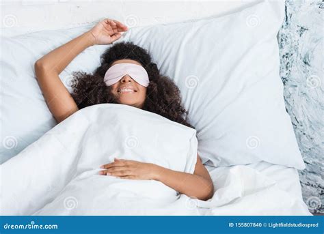Smiling African American Girl With Eyes Covered By Sleeping Blindfold