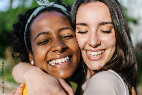 Candid Happy Multiracial Best Women Friends Embracing Outdoors Close
