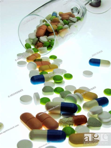Different Kinds Of Pills Spread Out In Front Of A Fallen Glas Stock