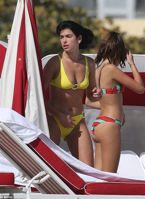 Dua Lipa Showcases Her Slender Figure In A Yellow Bikini On Beach Date