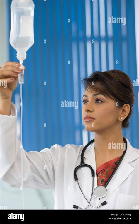 Female Doctor Checking A Saline Drip Stock Photo Alamy