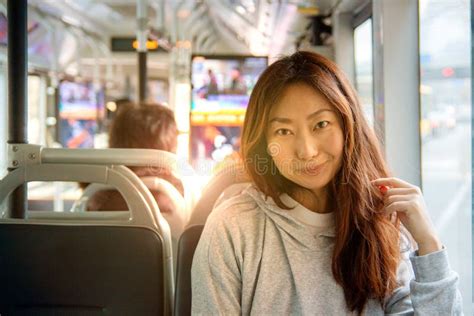 Young Pretty Asian Woman Traveling By Train Or Bus Sitting Near The Window And Taking Selfie