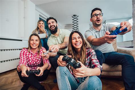 Group Of Friends Play Video Games Together Stock Photo Download Image