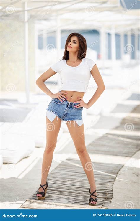La Fille Sexy Dans Des Jeans Court Circuite Sur Une Plage Photo Stock Image Du Jeans Femme