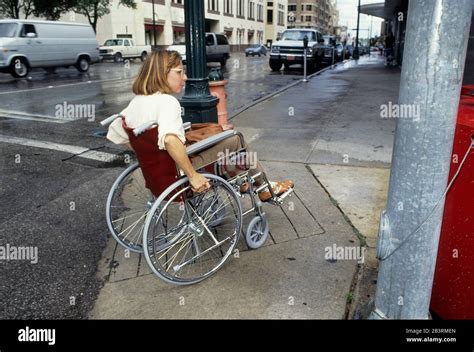 Austin Texas Usa Handicapped Woman In Wheelchair Uses Curb Cut And