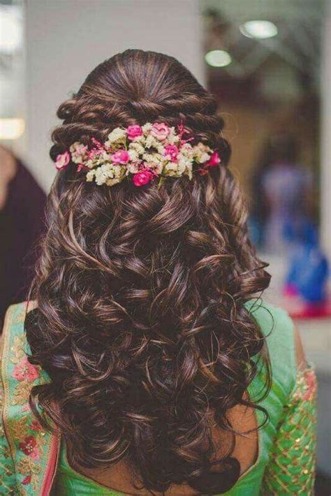 Then, after adoring a traditional bun on your add more volume in your hair by doing outwards curls. 10 Bridal Hairstyles For Curly Hair That Are Perfect For Indian Weddings! - Blog