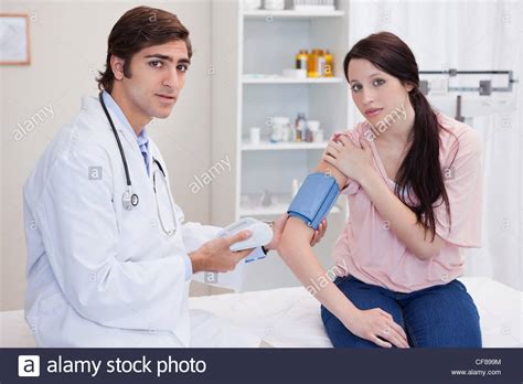 Doctor Taking Female Patients Blood Pressure Stock Photo Alamy