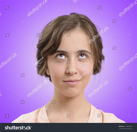 Portrait Of Attractive Teenage Girl Think Looking Up Stock Photo