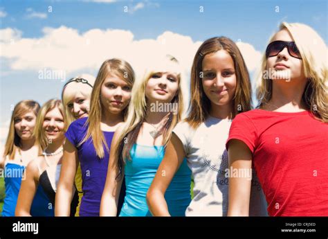 Group Of Teenage Girls Standing In A Row Behind Each Other Stock Photo
