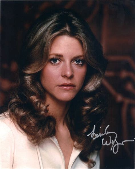 An Autographed Photo Of A Woman With Long Hair And Blue Eyes Wearing A White Shirt