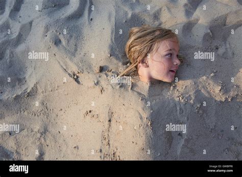 Young Girl Buried In Sand Hi Res Stock Photography And Images Alamy