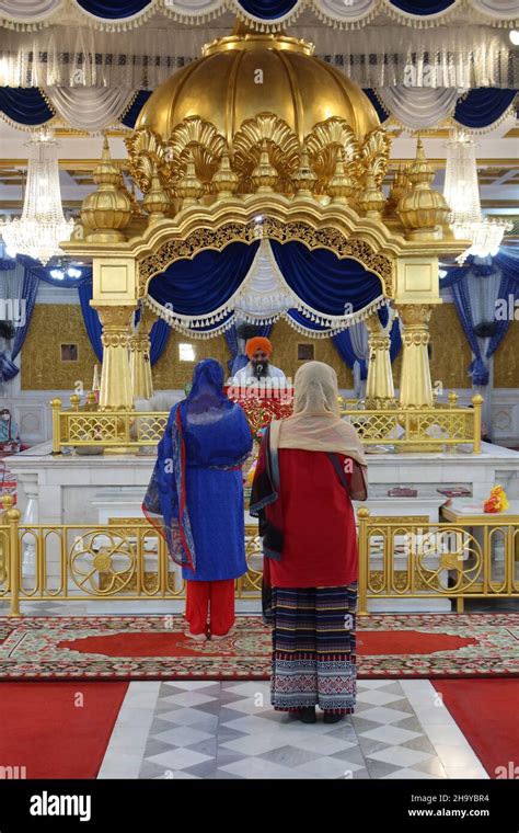 sikhs women at worship in gudwara sri guru sing saba sikh temple in bangkok thailand stock