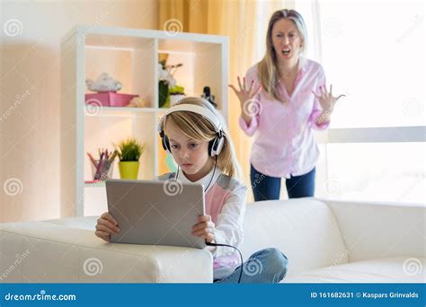 Mom Is Angry To Her Gadgets Addicted Teenage Daughter Stock Image