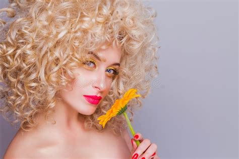 beautiful fashionable blonde girl in retro style with voluminous curly hairstyle open shoulders