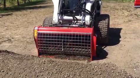 Scooping Gravel With A Cement Mixer Attachment For Skid