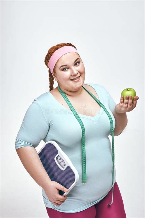 Funny Picture Of Amusing Red Haired Chubby Woman Which Is Holding A