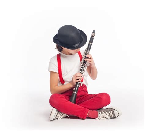 Premium Photo Little Girl Playing Clarinet On A White Background