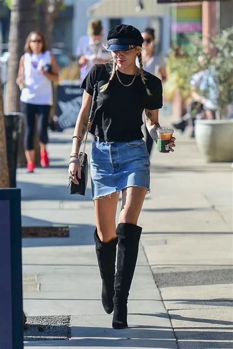 Miley Cyrus In Mini Denim Skirt And Knee High Black Boots