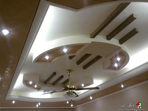 2 square pattern design fall ceiling 3 false ceiling design with multilevel structure and creative lighting 4 modern luxury ceiling design for for office building hall 5 gypsum false ceiling design with circular shapes below yellow lighting 6 spiral pop ceiling with pink red and grey designed drywall 7. احدث اشكال الجيبس امبورد 2012 والاضاءة المخفيه والاسقف ...