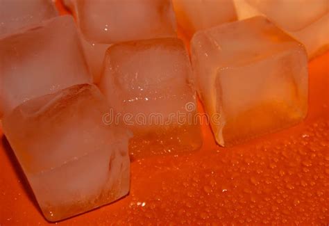 Pieces Of Ice On A Bright Background With Water Drops Orange Fresh