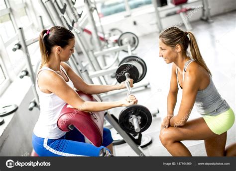 Young Women Exercising In A Gym — Stock Photo © Boggy22 147104869