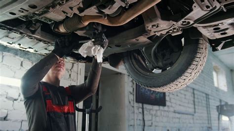 I will conduct careful examination on each automobile to accurately pinpoint the problem and suggest the correct solution. Bottom of car - Worker mechanic checks - automobile ...